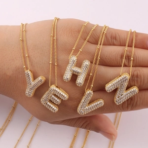 Golden balloon initial necklace set with CZ pavé letters Y, E, H, L, N on bead chains