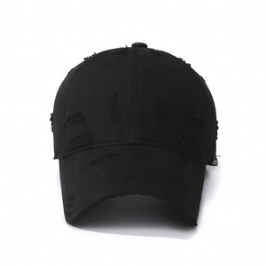 Vintage black distressed baseball cap with ripped details and retro cotton washed finish