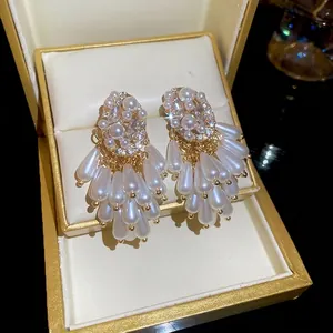 Elegant gold drop earrings with white pearls and sparkling rhinestones for women