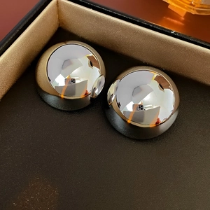 Detailed view of glossy silver hemispherical stud earrings in a premium jewelry gift box