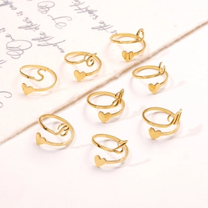 Collection of golden heart initial rings with adjustable open bands on white background