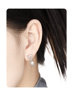 Close-up of elegant S925 silver stud earrings featuring white pearl and zircon on model