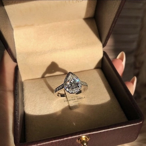 Elegant 925 sterling silver halo ring with pear-cut cubic zirconia in a jewelry gift box
