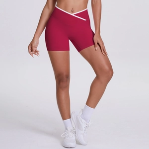 Close-up of burgundy high-waist yoga shorts with a cross V-waist and white contrast trim