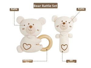 Detail of baby bear rattle set with natural wooden ring and soft organic cotton texture