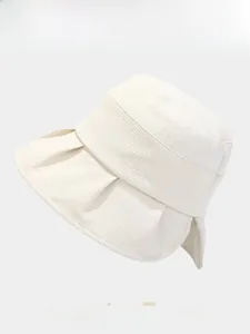 Detail of cream sun hat showing premium knit texture, wide brim, and side pleat details