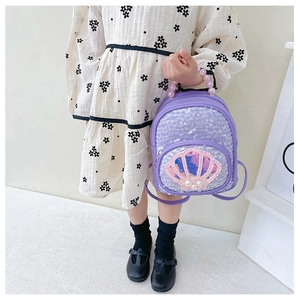 Detail of sequin shell backpack with pearl handle and lavender glitter material