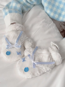 Detailed close-up of plush white gloves with sky blue lace, ribbon bow and pearl bead decor