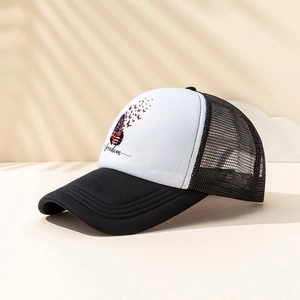 Detail of a trucker hat featuring a butterfly flag print and breathable black mesh material