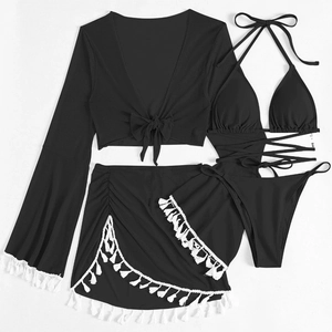 Detail of four-piece black bikini set showing long sleeves and white fringe skirt decoration