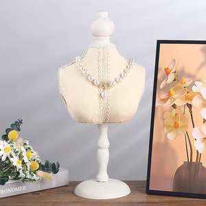Elegant pearl necklace with crystal CD pendant and drop pearl on a bust display stand