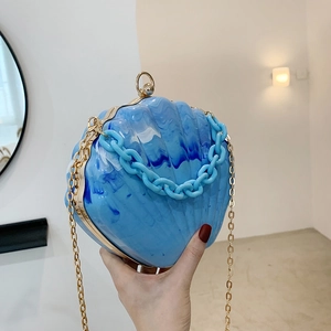 Blue marble acrylic shell clutch bag with gold chain strap and chunky plastic handle
