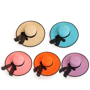 Summer wide brim straw sun hats with black chiffon bows in beige, blue, and pink