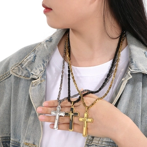 Three-layer cross pendant necklaces in gold, silver, and black on bamboo chain