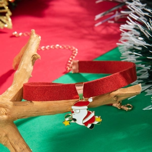 Velvet Santa Claus choker necklace with festive green background and Christmas decorations