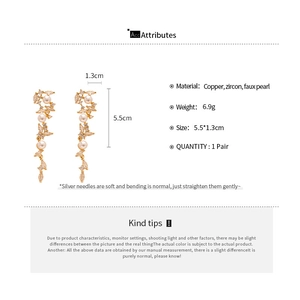 Detailed view of elegant drop earrings with zircons and faux pearls showing dimensions