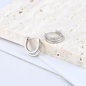 Close-up of geometric double hoop earrings featuring S925 silver and pave-set zircons