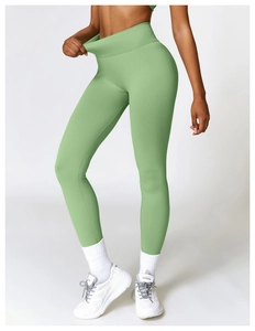 Detail of high-waisted yoga leggings showing the ribbed compression texture on the waistband
