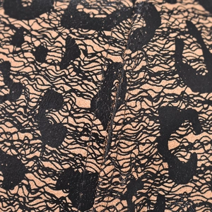 Macro shot of leopard print baseball cap fabric with reinforced stitching details
