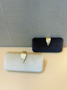 Elegant velvet evening clutch bag with leaf clasp in black and champagne gold colors