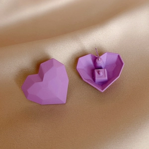 Faceted matte purple heart earrings on champagne satin showing front and back details