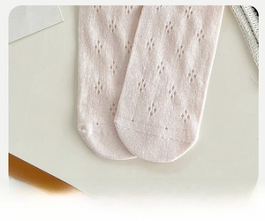 Detailed macro view of reinforced toe design on pink pointelle mesh cotton socks
