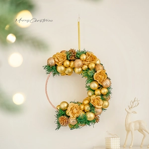 Golden crescent moon Christmas wreath with pine cones and ornaments on a festive background