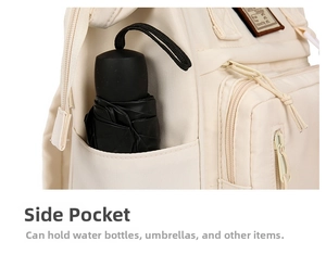 Detail view of the deep side pocket on a cream diaper bag holding a black folded umbrella