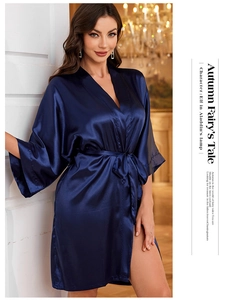 Detailed texture of navy blue satin bathrobe with silk-like sheen and elegant tie-waist