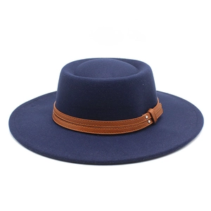 Detail of navy felt flat top hat with brown leather belt and silver buckle accents