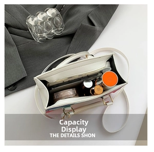 Interior capacity of the white leather tote bag holding a phone and cosmetics