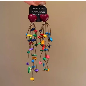 Detail of bohemian silver 925 heart earrings with colorful tassel beads and long fringe