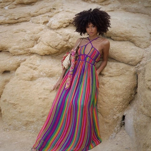 Detail of colorful rainbow striped maxi dress with halter neck and backless design