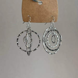 Detailed macro view of silver layered hoop earrings with textured hammered metal finish
