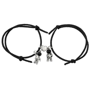 Magnetic astronaut couple bracelets with black braided rope and silver heart pendants