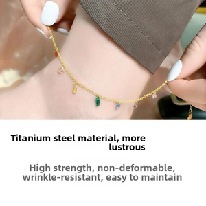 Detail of 18K gold titanium steel anklet with colorful rainbow crystal charms on ankle