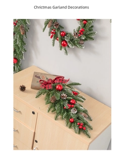 Close-up of Christmas wreath with snowy pine needles, red berries, and pine cones