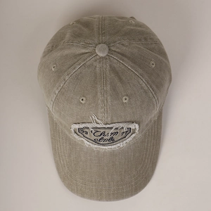 Close-up of vintage washed cotton baseball cap featuring distressed edges and patch