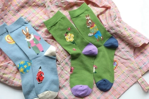 Detail of cotton crew socks featuring whimsical rabbit and mushroom jacquard patterns