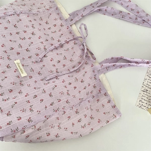 Close-up of floral tote bag showing lavender pattern, textured fabric and tie closure
