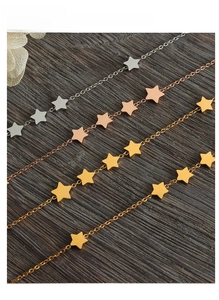 Detailed view of pentagram tassel chains in gold, rose gold, and silver finishes