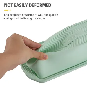 Green rectangular silicone bread mold showing high flexibility and heat resistance