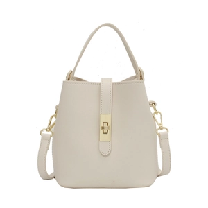 Chic beige leather bucket bag with gold swivel lock and adjustable shoulder strap