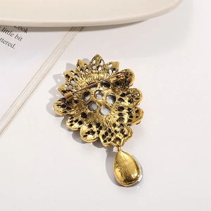 Detailed back view of vintage sunflower brooch with secure pin clasp and drop pendant