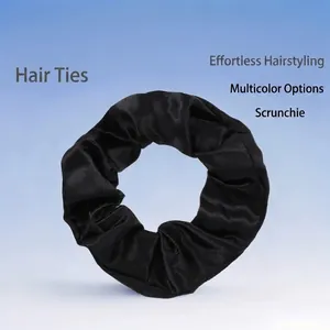 Elegant black satin silk scrunchie with soft fabric folds and premium elastic tie