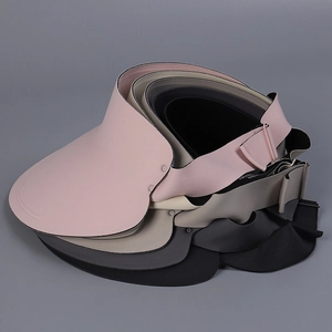 Detail of adjustable buckles on various colored summer sun visors with wide brims