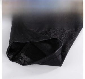 Close-up of black bridal glove fabric showing fine flat-stitched edges and silky texture