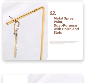 Detail of gold dangle earrings with small zircons on a dual-use jewelry display stand