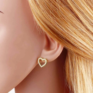 Minimalist 18k gold plated heart stud earrings with cubic zirconia on female model