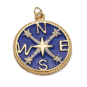 Detailed view of a gold compass pendant with blue enamel and sparkling small crystals